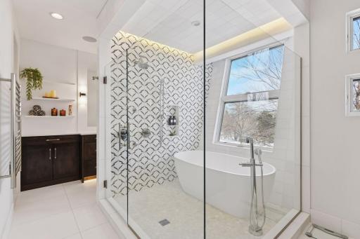 Glass shower room with custom title, architecturally designed window