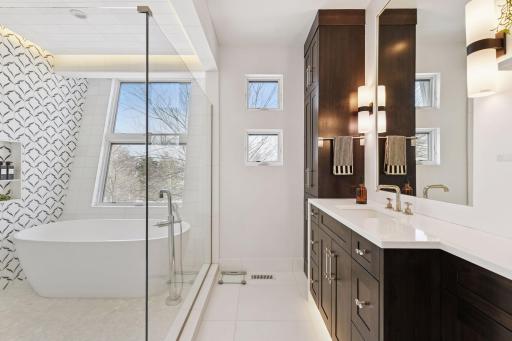 Spa-like bath with heated floors, glass shower room, and heated towel rack