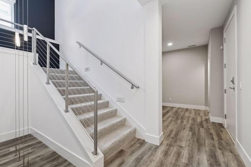 Architecturally pleasing stairwell with natural light on both landings. Additional storage room to the right as you walkin