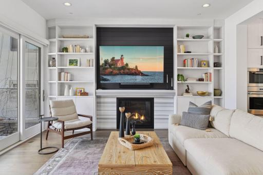 Gorgeous temperature controlled fireplace with custom stone, shiplap accent wall for TV (TV and bracket can stay with home)