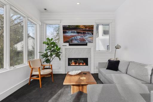 Main floor Sun room is surrounded on 3-sides by windows. Gorgeous marble gas fireplace plus transite heated floors.