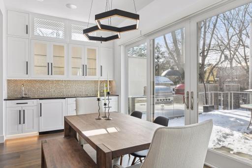 Bar area with additional sink, and freezer. Pop-up electrical service. Beautiful glass front cabinets for display
