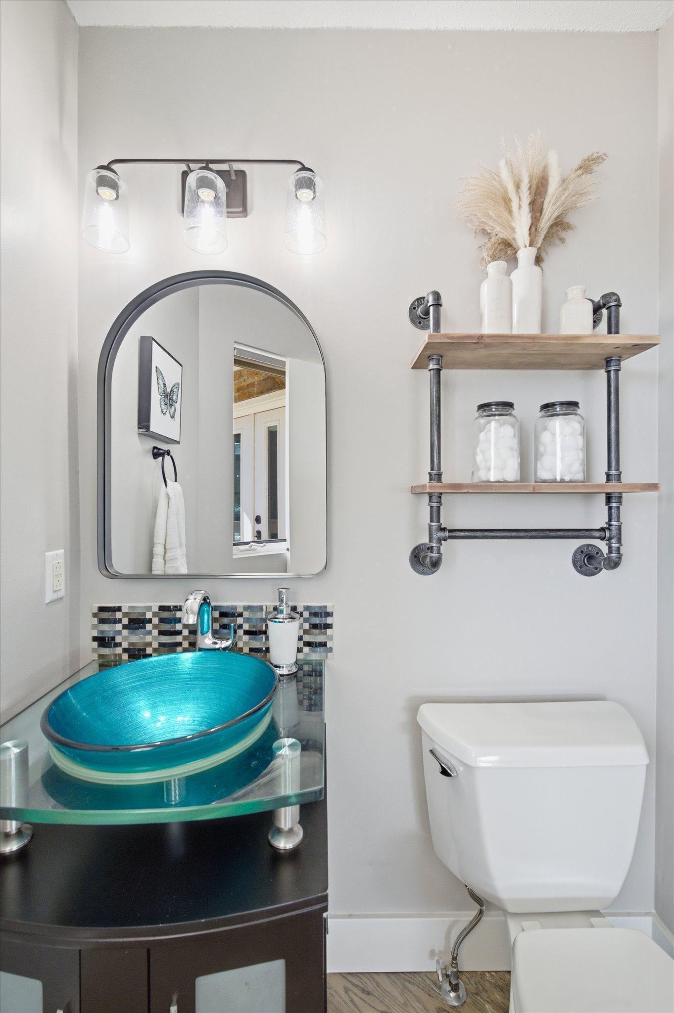 Stylish main-level powder room with modern vessel sink and updated fixtures.
