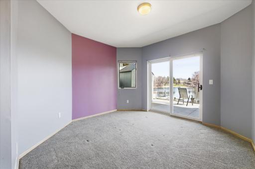 Additional lower-level bedroom with sliding door access to patio and lake views.