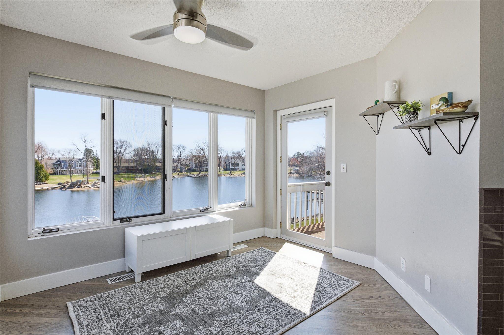 Flex space with panoramic lake views and direct sightlines to the living room.