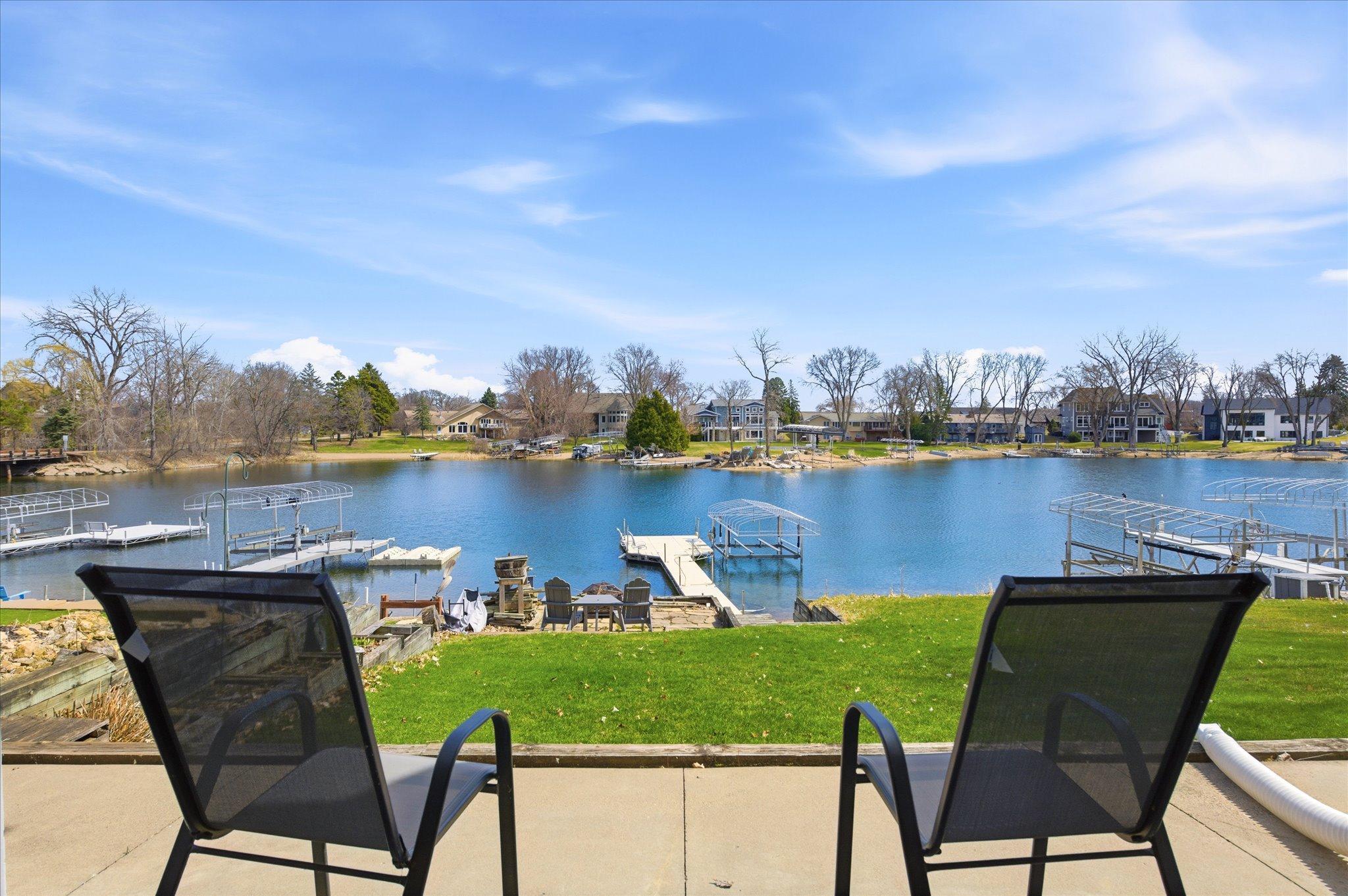 Elevated lake view from patio, showcasing expansive water views and a peaceful setting.