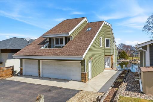 Stunning front elevation featuring a 3-car garage, updated exterior finishes, and a modern architectural design.