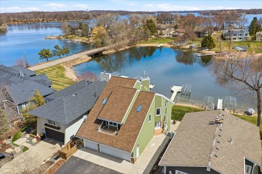 Aerial view highlighting the home’s unique architectural design and upper-level balcony.