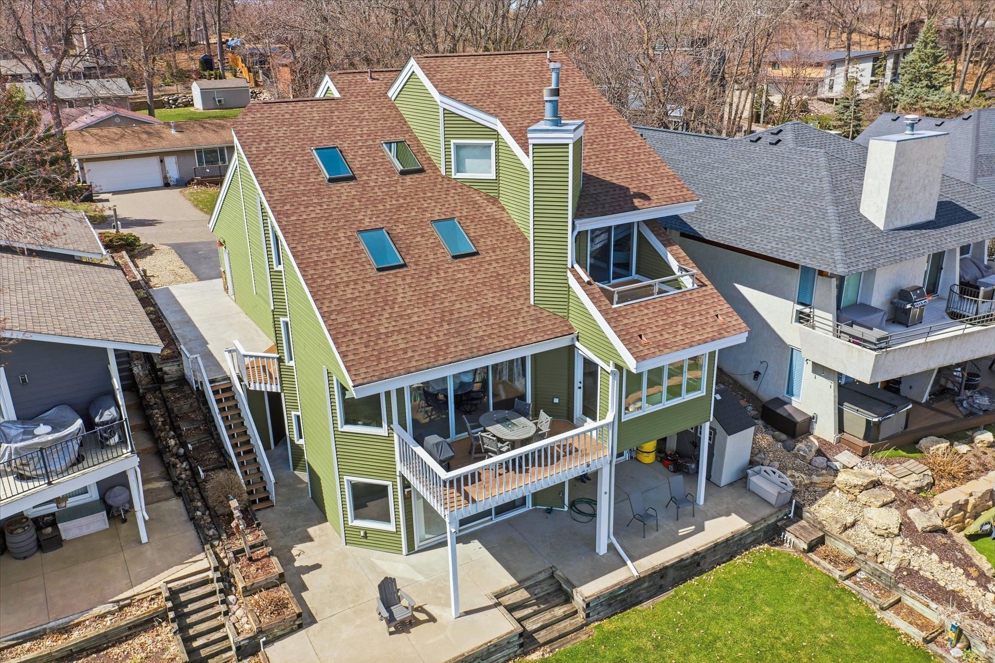 Rear exterior with multi-level decks and walkout lower level, designed to maximize lake views.