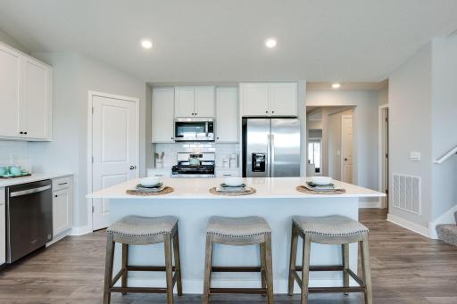 Kitchen highlights include stainless steel appliances, tiled backsplash and quartz countertops. *Picture is of model home; actual finishes may vary.