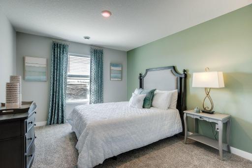 Lower level guest bedroom making this a 4 bedroom house. *Picture is of model home; actual finishes may vary.