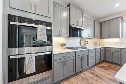 Energy star efficient, stainless steel appliances are present throughout the kitchen - including wall oven and 5-burner gas cooktop.