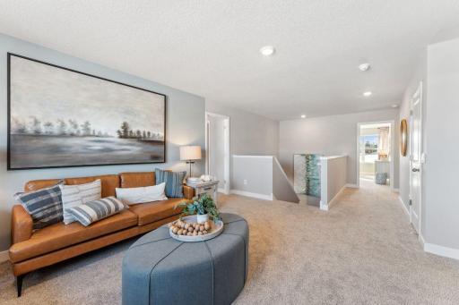 Greeting you at the top of stairs is an oversized loft space which is a great place for those informal or end of the day relaxation time.