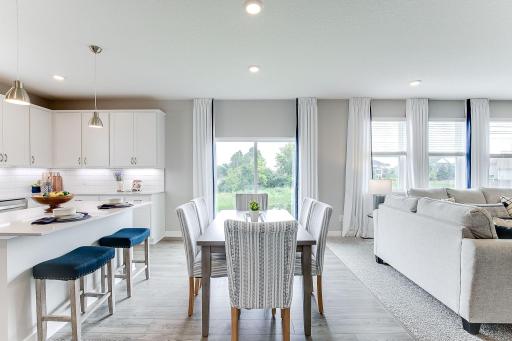 Kitchen and dinette with more seating at the breakfast bar.