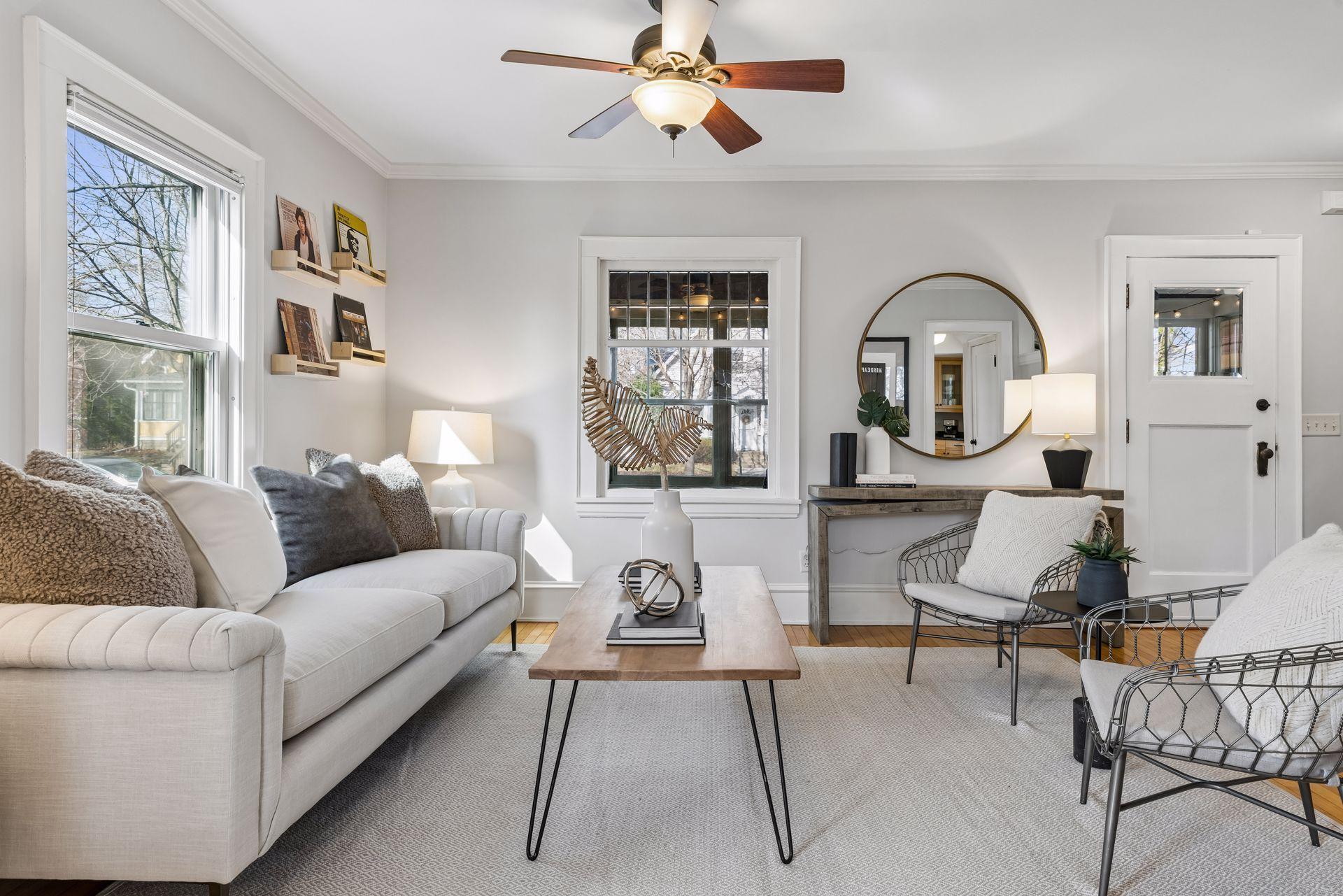 Living room is bright and open across beautiful hardwood floors