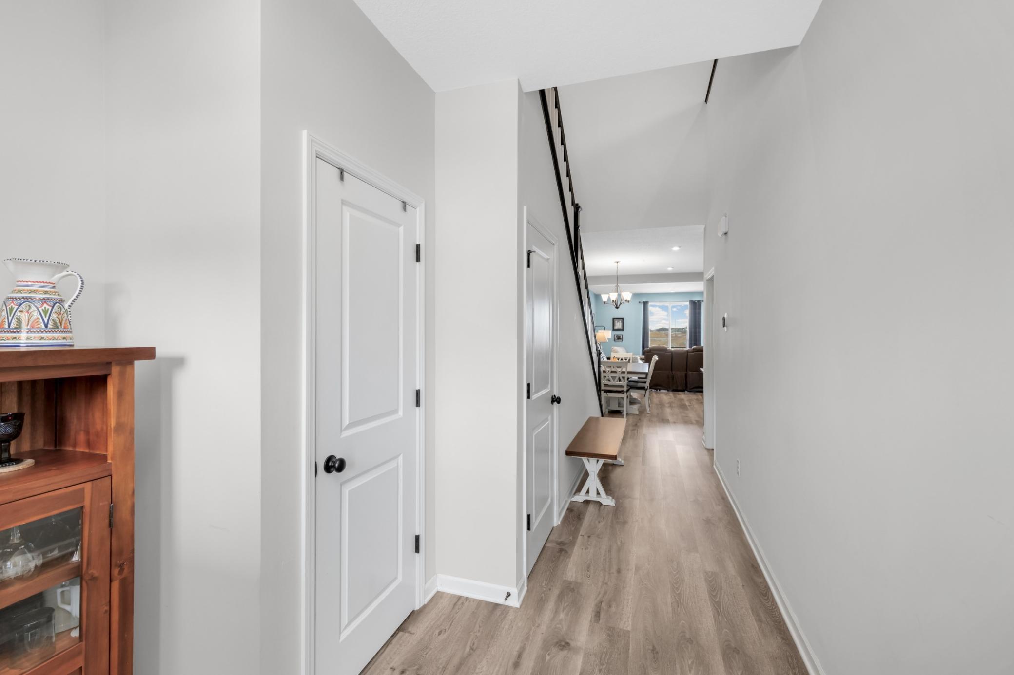 entry hall closet and door to the lower level