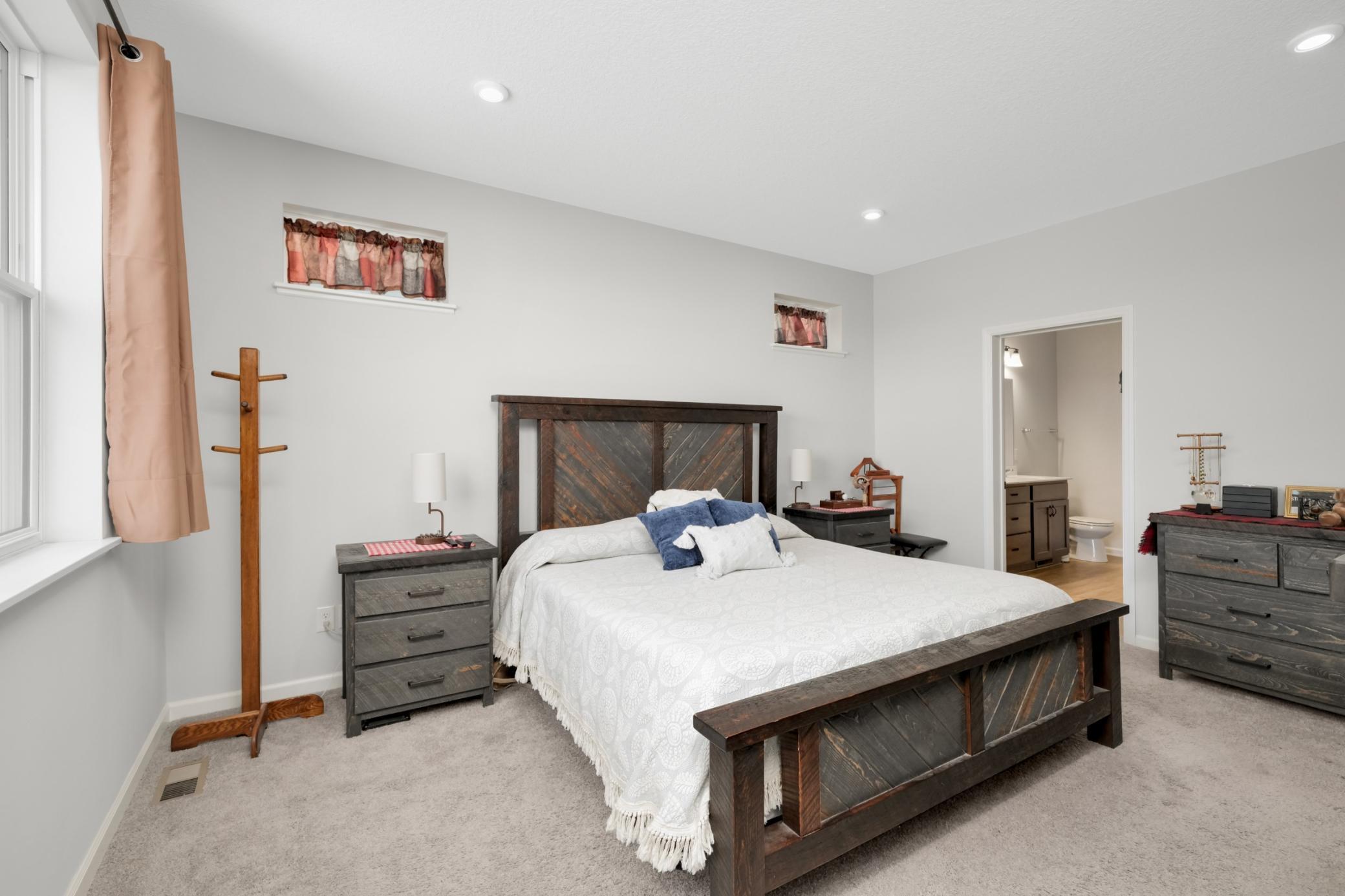 MAIN FLOOR primary bedroom with gorgeous natural light