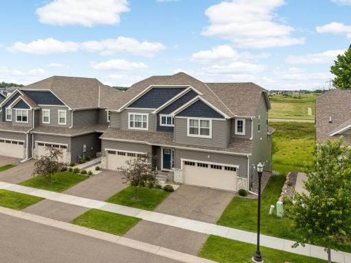 Welcome home to this stunning end-unit townhome featuring timeless Craftsman style curb appeal