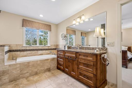 A soaking tub, lovely tile, and quality granite vanity complete the bathroom!