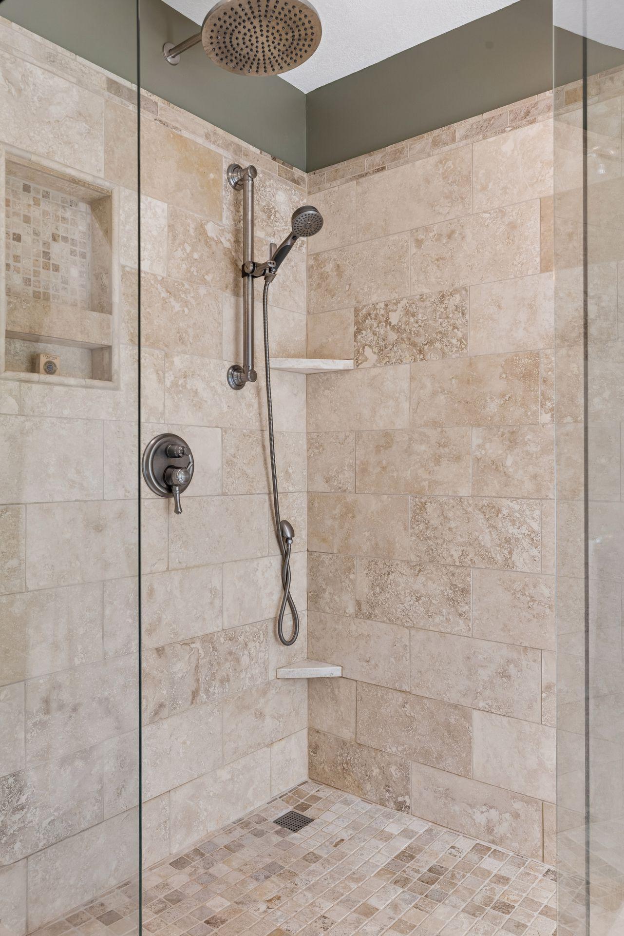 Walk-in tiled shower with sleek glass surround