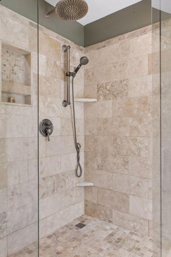 Walk-in tiled shower with sleek glass surround