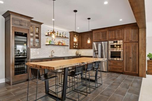 Designed by w.b. builders, the lower level offers a family room, stunning full wet bar with custom cabinetry, game area, exercise room, guest bedroom, and bathroom.