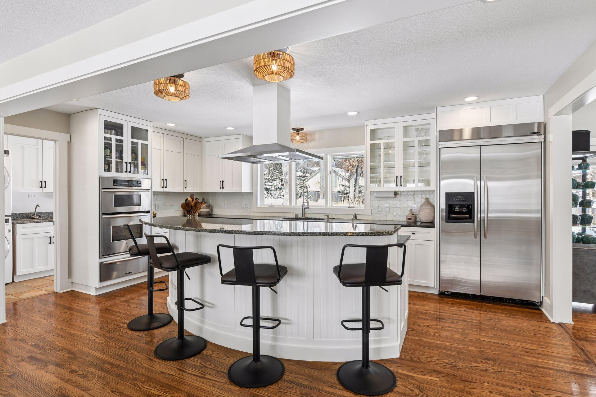 Updated chef's kitchen with stainless steal appliances, granite counters, with a lovely window overlooking the backyard