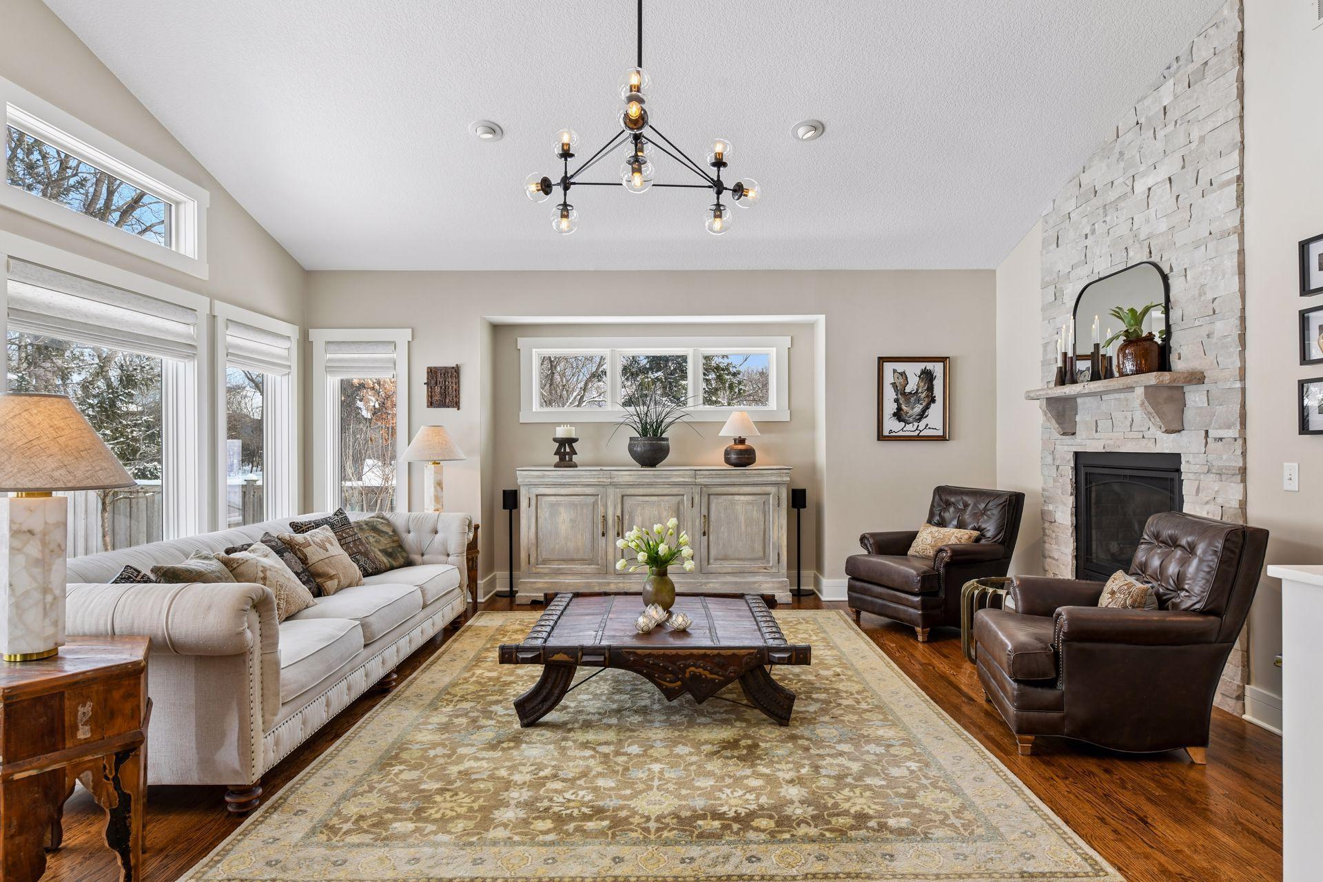 Open and bright upper level living room with 2-sided gas fireplace