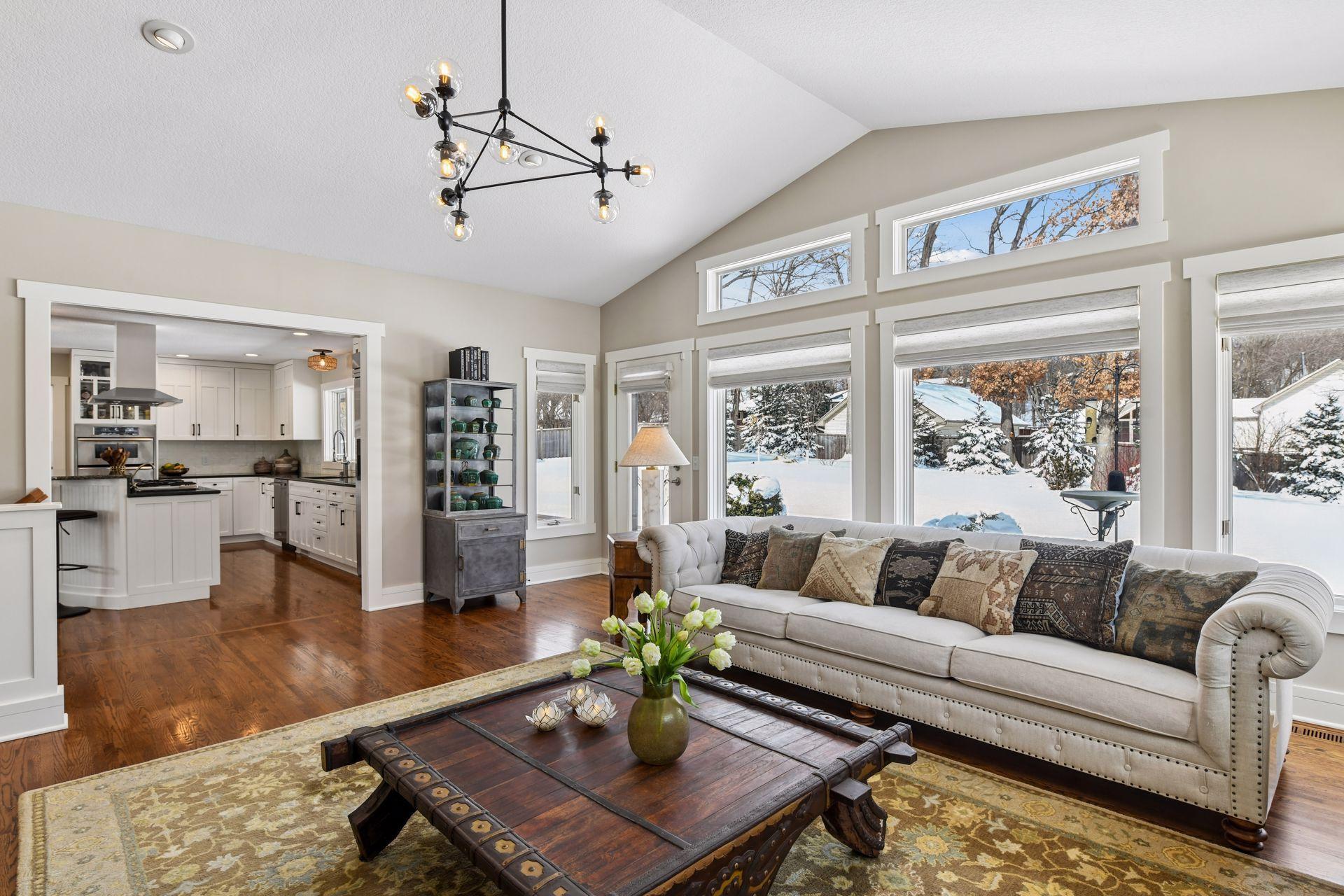 Living room with an abundance of natural light, overlooking the private backyard