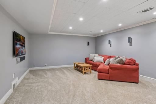 Expansive lower-level amusement room with endless possibilities for entertaining, relaxing, or creating your dream space.