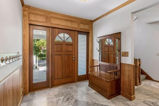 Welcoming front entry featuring custom millwork and beautiful tile flooring.