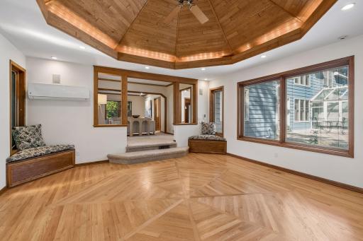 Absolutely stunning sunroom featuring a warm cedar vaulted ceiling and beautiful hardwood flooring.