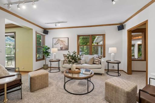 Another wonderful living space for gathering and relaxing that opens to the formal dining area.