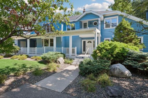 Lush, mature landscaping and distinctive architectural details create an inviting first impression.