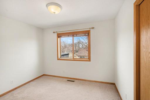 The 3rd bedroom on the upper level also has an updated light fixture, and a west-facing window with wood blinds & seasonal lake views.