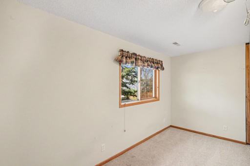 This flex room can be used as a 6th bedroom (no closet) or an office. The interior walls can easily be removed to make the family room bigger again. It has a west-facing window with wood blinds & an updated light fixture.