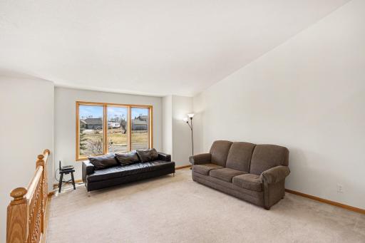 The living room features: a vaulted ceiling; and a east-facing window - which provides lots of natural light.