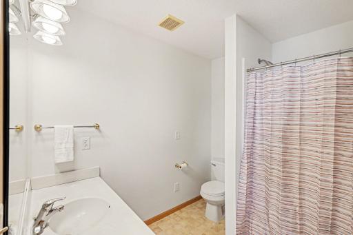 The private, primary 3/4 bathroom features a nice size vanity and an exhaust fan.