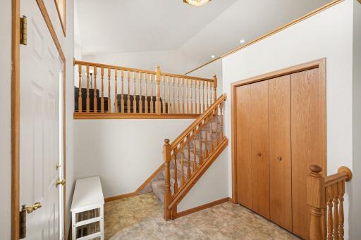 The 2 story foyer features: a generous coat closet, and an east-facing door with sidelight & overhead transom window - for lots of natural light.