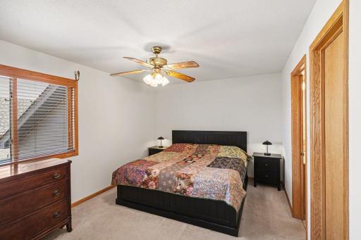 The primary bedroom suite features: a 6.11X4.3 walk-in closet, private 3/4 bathroom, a ceiling fan, and a north-facing window with wood blinds.