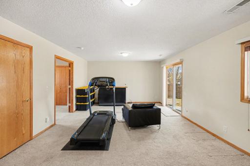 The lower level family offers access to: an 8.9x10.9 under staircase storage area (which houses the sump basket & pump), & the sliding glass door leading to the 10x10 patio & backyard. This room also has a west-facing window & updated light fixtures.