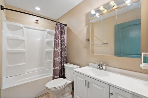 The main floor full bathroom with tub and shower combo.