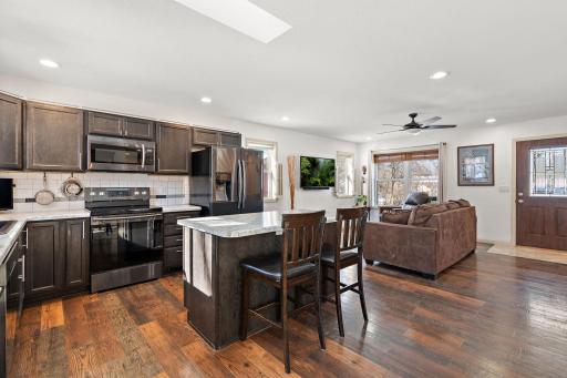 The kitchen has plenty of storage cabinets and a nice island counter for informal dining or for buffet style hosting during a gathering of friends and family.