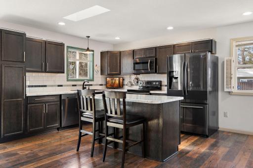 The kitchen is nicely situated with plenty of counter space for cooking or hosting and ample cabinet space, too. The kitchen sink window offers a view of the backyard.