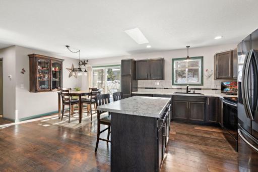 The informal dining room features a hanging china cabinet and a backyard access through the sliding glass patio door.