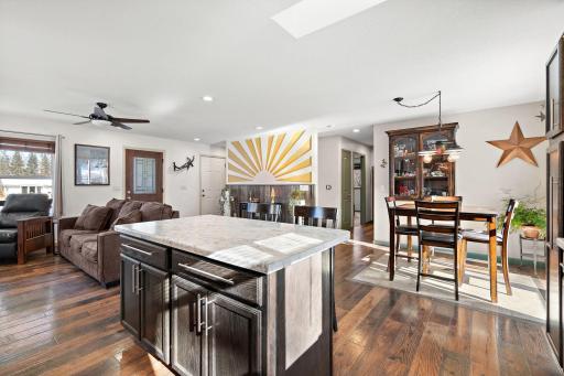 Standing in the kitchen facing the living room and informal dining area. The hallway with the main floor bathroom and bedrooms can be seen directly across the room.