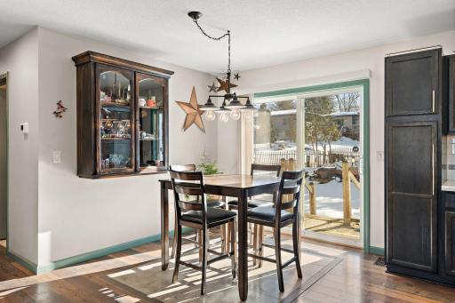 The informal dining area with the hallway to the main floor bathroom and bedrooms visible on the left.