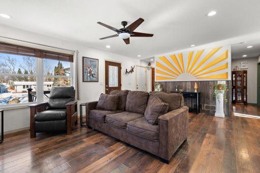 The main floor has an open concept floor plan with the living room, main entry and dining area all sharing one space. The room is open and spacious with plenty of natural light and beautiful flooring throughout.