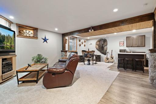 The lower level features a cozy family room with a wet bar, perfect for hosting, relaxing or enjoying hobbies.