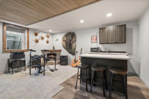 The lower level wet bar and note that there is also an electric fireplace for additional ambience and coziness.